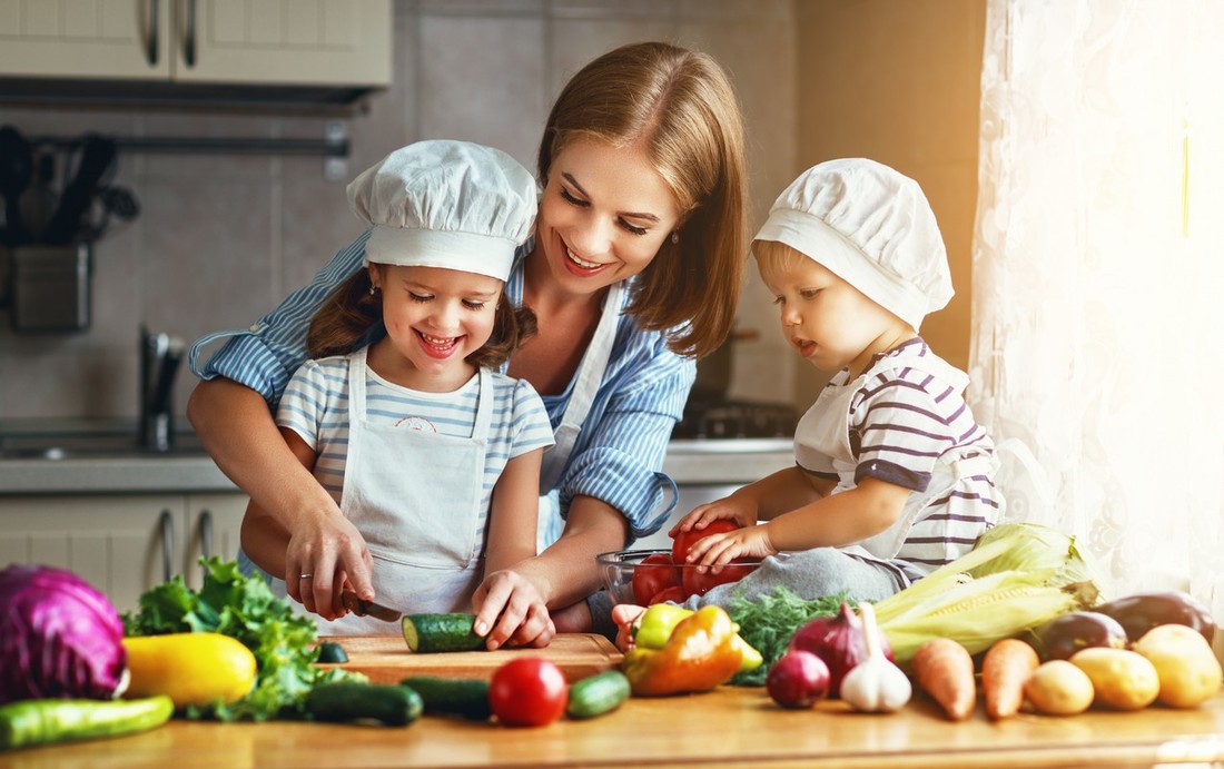 mother and children prepares vegetable salad